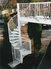 Weiße Spindeltreppe mit Gehsteig. Der Unterschied zwischen Spindeltreppen und Wendeltreppen verbildlicht.